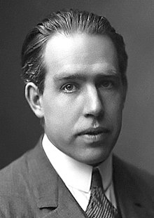 Photograph showing the head and shoulders of a man in a suit and tie