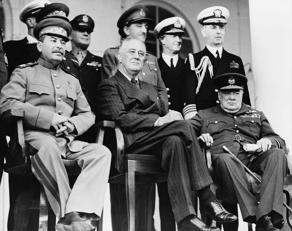 Teheran, Iran, Dec. 1943—Front row: Marshal Stalin, President Roosevelt, Prime Minister Churchill on the portico of the Russian Embassy—Back row: General H.H. Arnold, Chief of the U.S. Army Air Force; General Alan Brooke, Chief of the Imperial General Staff; Admiral Cunningham, First Sea Lord; Admiral William Leahy, Chief of staff to President Roosevelt, during the Teheran Conference