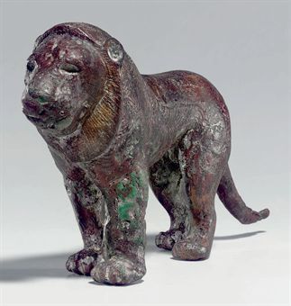 A SYRIAN COPPER ALLOY LION LATE URUK PERIOD, CIRCA MID 3RD MILLENNIUM B.C. Solid cast, standing with the left legs advanced, the long tail curving out, the mane a series of incised, concentric curving lines, the pattern extending along the flank, the ruff with incised striations, the eyes recessed for now-missing inlays, the semicircular ears nearly flat against the head