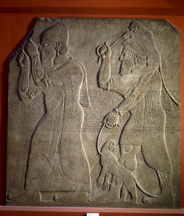 G:\pix\projects\iranzamin\1200-550\-850 A labaster wall panel showing tribute bearers. One has a North West Syrian type turban and raises clenched hands in token of submission; the second may be Phoenician and brings a pair of apes.jpg