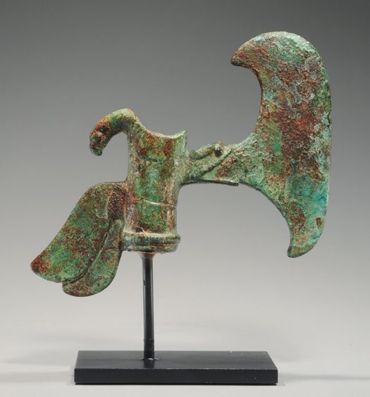 LURISTAN BRONZE SHAFT-HOLE AXEHEAD | With rounded lunate blade, curled protrusion at back. A sheepâs head projecting from the back of the shaft hole, the blade emanating from a serpentâs mouth. Ca. 2100-1750 BC