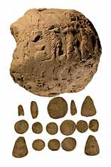 Sumerian clay envelope with tokens inside, 3700-3200 BC. This was an important step in the development of writing - the symbols stamped in the clay to show the number of tokens inside eventually came to replace the tokens themsleves.