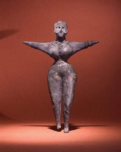 This ceramic woman figurine from Tureng Tepe, Iran was made around 3500 BCE. She is a burial offering and altho she is not clothed, she is adorned with many bracelets, necklaces and an elaborate headdress. Penn Museum Object #32-41-25.