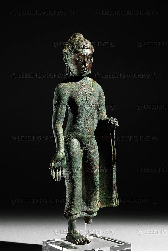 INDIAN BRONZE 8TH     Bronze statue of Buddha, the Deccan, India, 8th CE. The right hand of the statue is shown in the gesture of charity (varadamudra). The Buddhas robes are barely visible and his right shoulder is bare. Buddhism began to decline in India after the 5th century and the collapse of the Gupta Empire. This image is evidence for the continued practice of Buddhism in southern India into the 8th century. OA 1905.12-18.1     British Museum, London, Great Britain