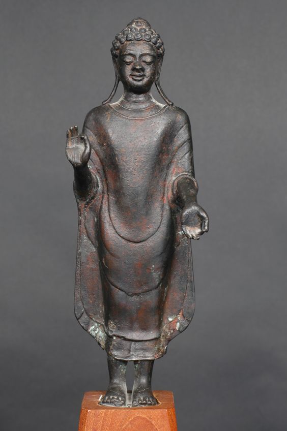 Mon-Dvaravati bronze image of Buddha, 8th century Thailand 11.5". Gupta style robes.