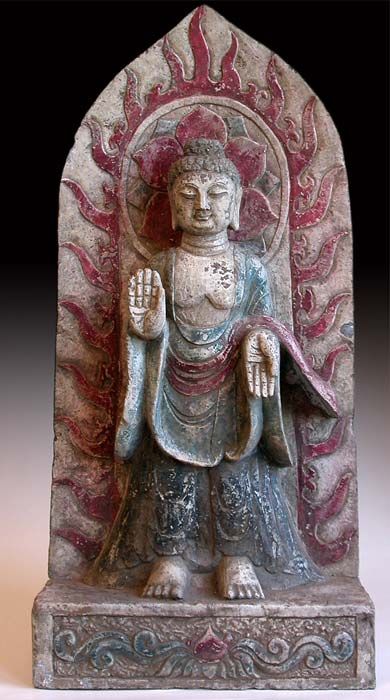 Shakyamuni displays the vitarka mudra on his right hand pointing towards the heavens, while his left displays the varada mudra downwards towards the earth. These mudras are gestures of protection and charity, respectively. (China, circa: Ming Dynasty, 1368-1644 A.D.)