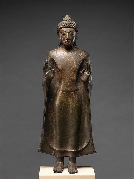 Standing Buddha Period: Mon-Dvaravati period Date: 8thâ9th century Culture: Thailand (Nakhon Pathom Province) Medium: Bronze with traces of gilt Dimensions: H. 27 in. (68.6 cm); W. 10 1/4 in. (26 cm); D. 5 3/8 in. (13.7 cm)