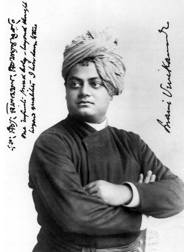 Black and white image of an Indian man, facing left with his arms folded and wearing a turban